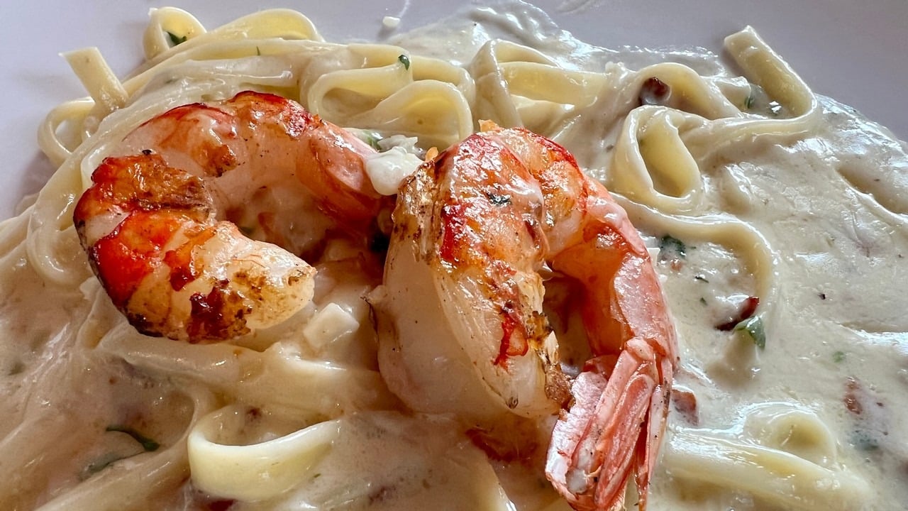 Fettuccine carbonara. bacon, caramelized shallots, Parmesan cream sauce with shrimps